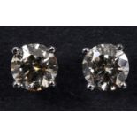 A pair of 18ct white gold and diamond stud earrings Report by JS Diamonds approx. 5.0 mm diameter, a