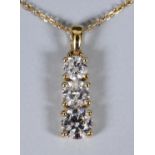 An 18ct gold and diamond drop graduated pendant necklace