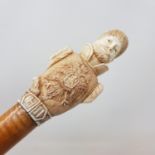 An Early 20th century walking stick, with carved ivory handle in the from of Tsar Nicholas II, on