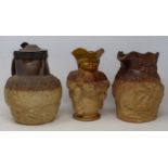 An early 20th century Doulton Lambeth stoneware character jug, 20 cm high, and two Harvest jugs (