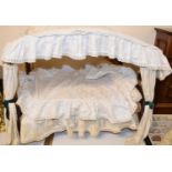 A late 19th/early 20th century doll's four poster style bed, with some drapes, 63 cm wide x 53 cm
