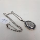 A late 19th century silver oval locket and chain, marks rubbed