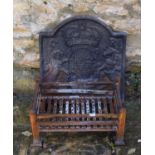 A cast iron fire back, 55 cm wide and a fire basket