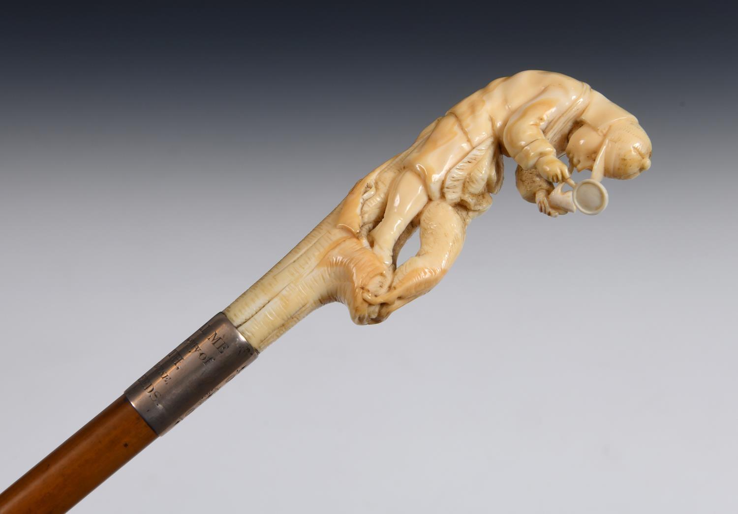 A 19th century walking stick, with a carved ivory handle depicting Sherlock Holmes with a