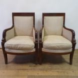 A French Empire style mahogany three piece suite, comprising a sofa, 180 cm wide, and a pair of