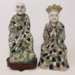 A pair of Chinese figures, of men in robes, 23 cm high (2) figure with crown, various chips to crown