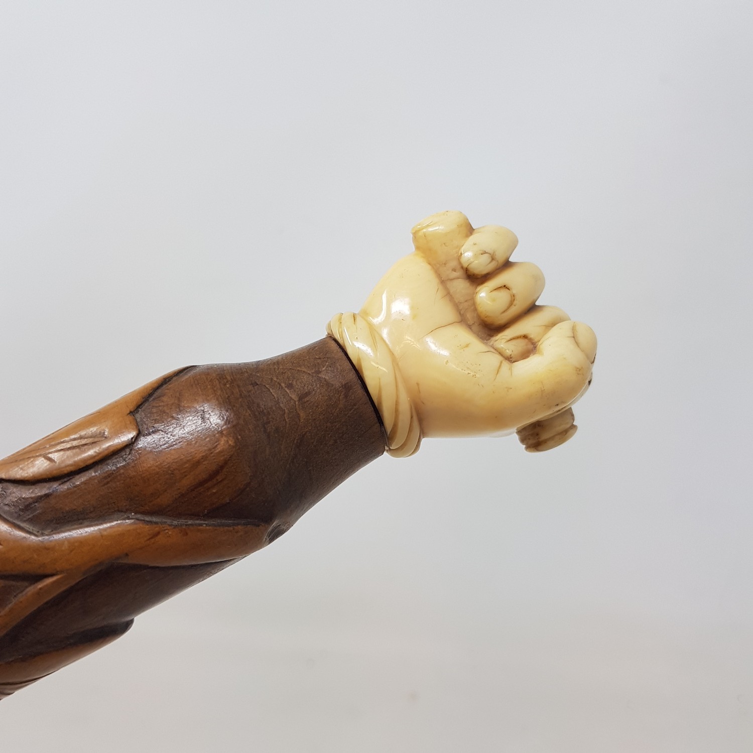 An Early 20th century walking stick, with carved ivory handle in the from of a hand, on a foliate - Image 2 of 6