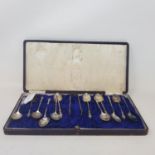 A set of twelve silver coffee spoons, with matching sugar tongs, with apostle type finials,