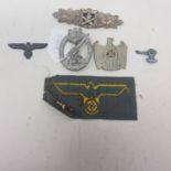 A German Third Reich Anti Aircraft badge, a German NSKOV cap badge, eagle facing right, and other