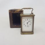 An early 20th century carriage clock, with a lever escapement, the white enamel dial with Roman
