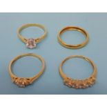 A 22ct gold wedding band, 1.7 g, and three 18ct gold dress rings (4) Three 18ct gold rings, 8.2 g (