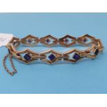 A yellow metal bracelet, inset with purple stones, 18 cm long Weight 12.6g (all in)