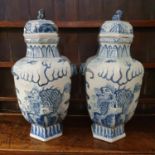 A pair of Chinese blue and white vases and covers, decorated with dragons, 70 cm high