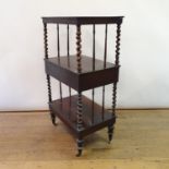 A 19th century rosewood three tier whatnot, with a central drawer, on turned legs, 59 cm wide