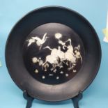 An early 20th century Japanese black lacquered plaque, decorated cranes and flowers, 40 cm