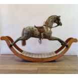 A Victorian style fibreglass rocking horse, on wooden bow rockers, 220 cm wide