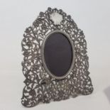 An Indian white metal photograph frame, with pierced foliate decoration, makers mark MR BHUJ, 23