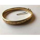 A 9ct gold bangle, with engraved decoration, 13.0 g
