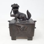 A Chinese bronze box, with a Dog of Fo finial, having a drawer to the front on shaped bracket