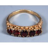 An early 20th century yellow metal, five stone garnet and diamond ring, ring size O