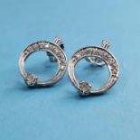 A pair of white gold and diamond set halo style earrings