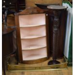 A 19th century mahogany corner cupboard, 76 cm, another, a brass fender, and a mahogany pedestal