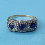 An 18ct gold and triple sapphire cluster ring, ring size T½ The ring is modern