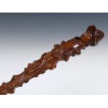 A 19th century folk art walking stick, the handle carved in the form of a woman and dog, with