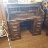 An oak tambour front kneehole desk, 125 cm wide