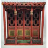 A Chinese doll's type house, with natural wood, red painted and gilt decorated, the dwelling