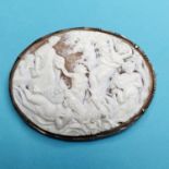 A late 19th century cameo brooch, carved Bacchus and other figures, in a silver coloured metal