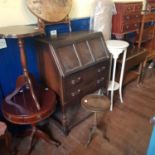 An oak refectory dining table, an oak bureau, mahogany table, two wine tables, and a painted