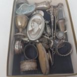 A George V silver oval photograph frame, an egg cup, a pepper pot, and other items