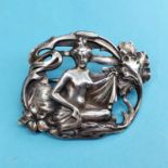 An Art Nouveau silver brooch, in the form of a nude with flowers