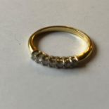 An 18ct gold and seven stone diamond ring, 2.6 g (all in)