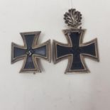 A German Knights Cross, with oak leaves (marked 800 L/12), and a First Class Cross, both of post war