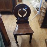 A 19th century mahogany hall chair, an oval mirror, a footstool, a coffee table, and a red ground