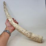 An early 20th century Congalese style carved tusk, 56 cm wide