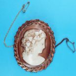 A 19th century oval shell cameo, carved a woman with ivy in her hair, 6 x 4.5 cm