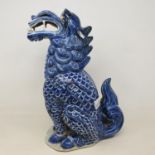 A Chinese blue and white figure of a dragon, 30 cm high slight loss
