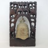 A Chinese bell, on carved hardwood stand, 39 cm high
