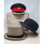 A military cap, in original box, a top hat, a bowler hat, a cast metal trivet, and other items (2