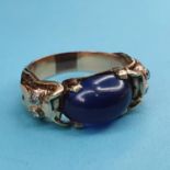 A yellow metal, cabochon cut amethyst and diamond ring, ring size approx. U