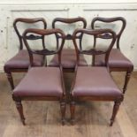 A set of six early Victorian rosewood dining chairs, with leather drop in seats, on lotus leaf
