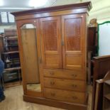 An early 20th century inlaid mahogany and compactum, having mirrored door, two cupboard doors and