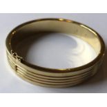 A 14ct gold bangle, with fluted decoration, 37.6 g