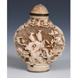 A Chinese white lacquered scent bottle, carved with birds, flowers and insects, four character
