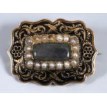 A Victorian yellow metal black enamel and a seed pearl memorial brooch, the back engraved 'Ollie