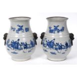 A pair of Chinese crackle glaze vases, of baluster form, decorated sage and other figures, with Dogs