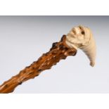 A 19th century walking stick, with a carved ivory handle in the form of a monkey wearing a tall